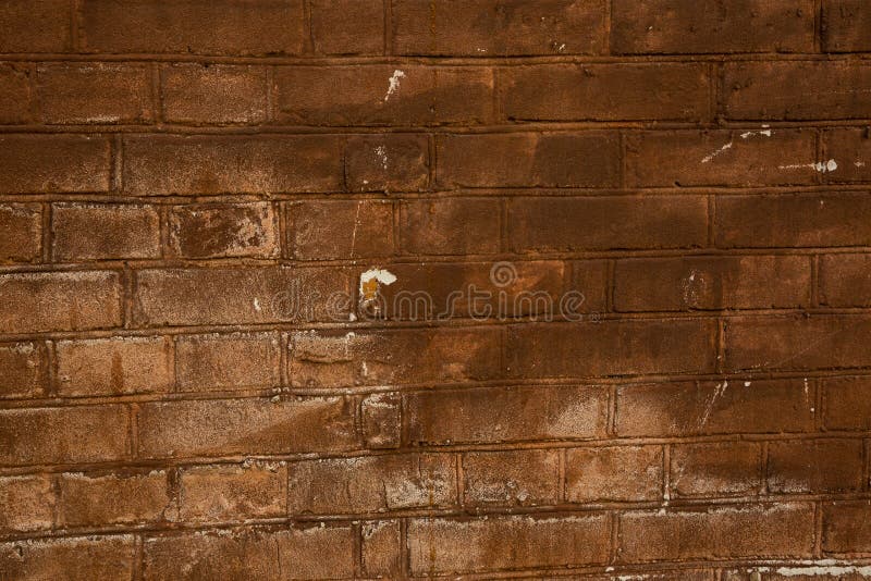 Old Brick Wall of Red Color with Scratches and White Spots. Stock Photo