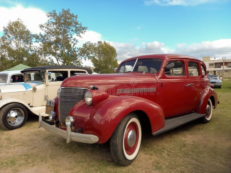 An old red 1939 Chevrolet Chevy Master sedan four-door by General Motors on the lawn