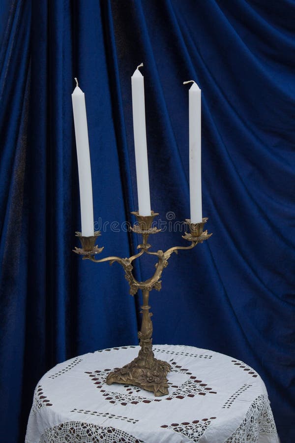 Burning Candles on a Table in Candlesticks from Bottles Stock Image