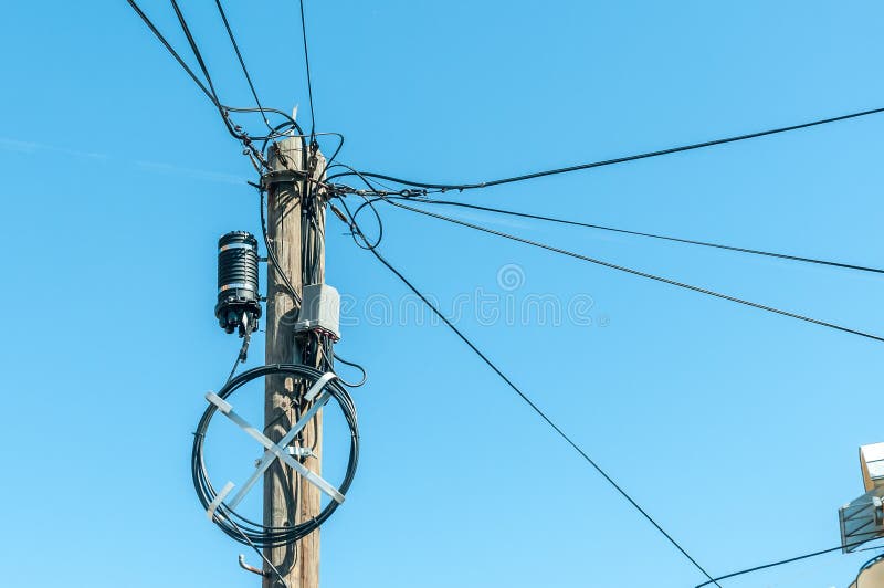 Old retro style wooden pole with many electric supply wires or cables for telephone communication with blue sky background royalty free stock photography Old retro style wooden pole with many electric supply wires or cables for telephone communication with blue sky background royalty free stock photography