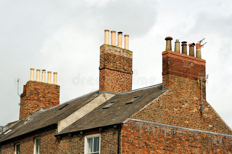 Old roof top with chimney pots on an English house. UK