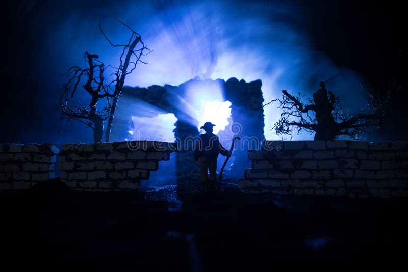 Old ruined stone house in deserted garden at night. Selective focus