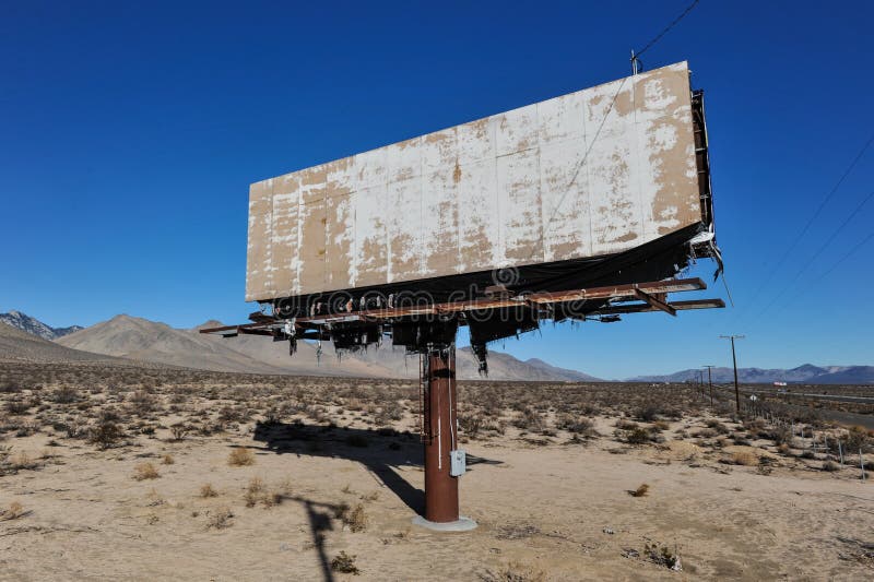 Old rusted blank billboard by road