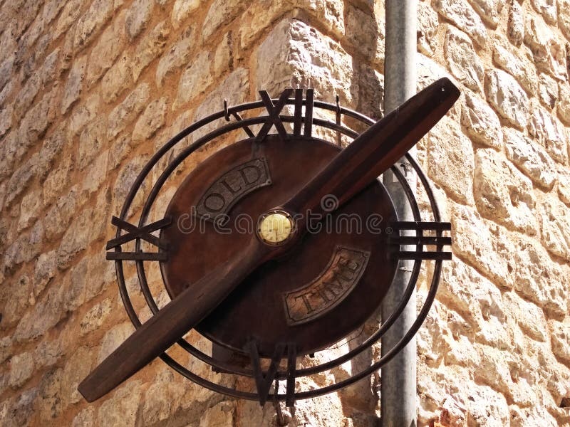 Old Rusty Clock On The City Wall. Old, rusty vintage clock on the corner of a stone house royalty free stock photography Old Rusty Clock On The City Wall. Old, rusty vintage clock on the corner of a stone house royalty free stock photography