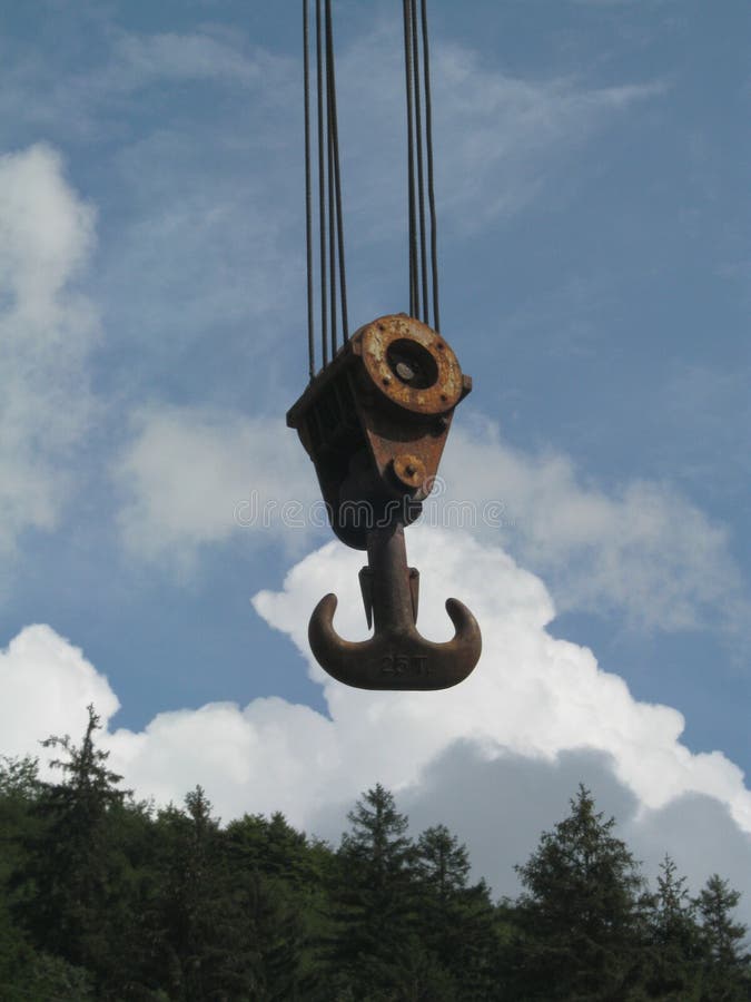 Old and rusty crane hook in the blue sky and white clouds. Load structural stock images, royalty-free photos and pictures