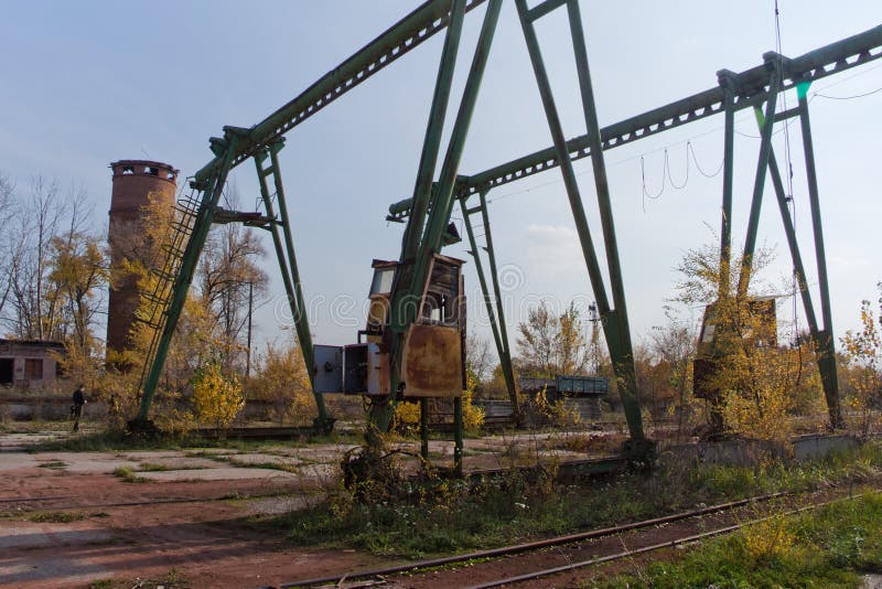 Old rusty gantry bridge crane in abandoned industrial area