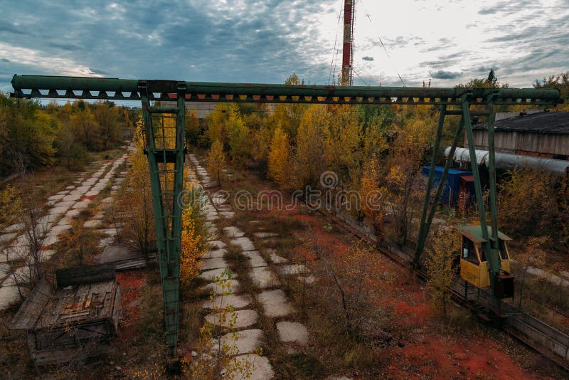 Old rusty gantry bridge crane in abandoned industrial area