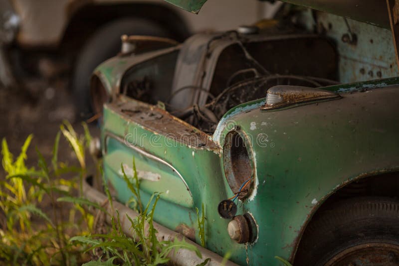 An Old Rusty Green Car. without Headlights and Hood Stock Photo Image