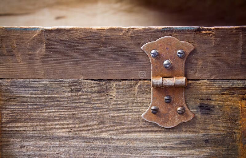 Old rusty hinge on a big old hardwood frame or a tool box