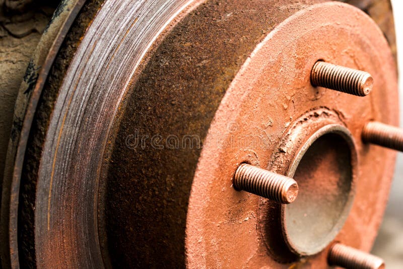 An Old Rusty Hub without a Wheel. Brake Disc and Brake Caliper on the