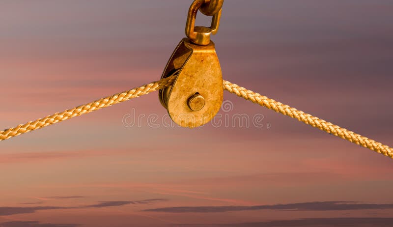 Rope on Pulley Against Blue Background Stock Photo - Image of ropes,  pulley: 16825344