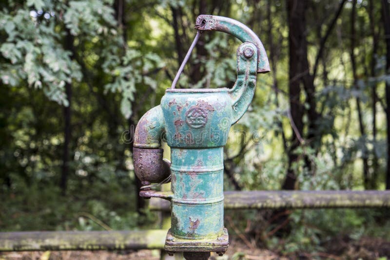 Old Rusty Water Pump in the Forest Stock Photo Image of chain, metal
