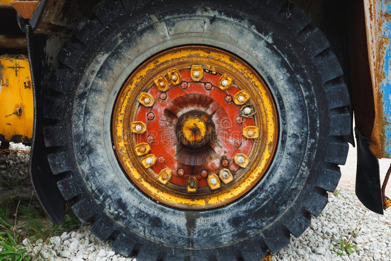 Old rusty wheel of haul truck