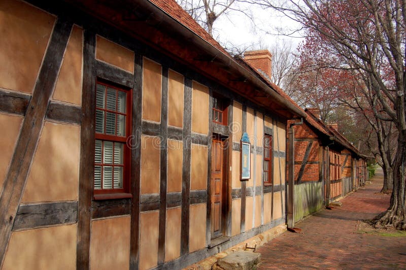 18th century half-timbered and stucco Apothecary shop sits next to several brick half-timbered buildings at the historic Moravian settlement in Old Salem, North Carolina. 18th century half-timbered and stucco Apothecary shop sits next to several brick half-timbered buildings at the historic Moravian settlement in Old Salem, North Carolina.