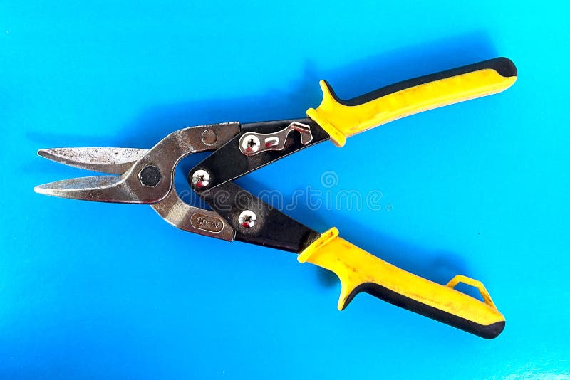 Old Scissors for Metal. Tool for Cutting Sheet Metal on a Blue