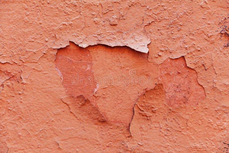 Old shabby wall texture with cracked peeling pink paint. Unique abstract background for design and text royalty free stock photo