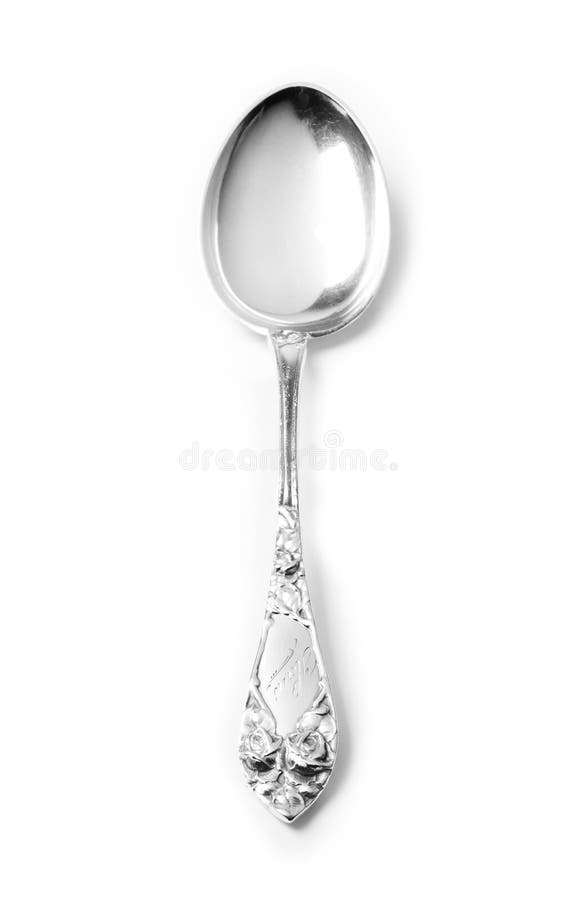 Old engraved silver spoon on white background. Old engraved silver spoon on white background