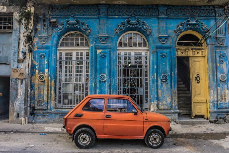 Old small car in front old blue house, general travel imagery, on december 26, 2016, in La Havana, Cuba. Old small car in front old blue house, general travel imagery, on december 26, 2016, in La Havana, Cuba