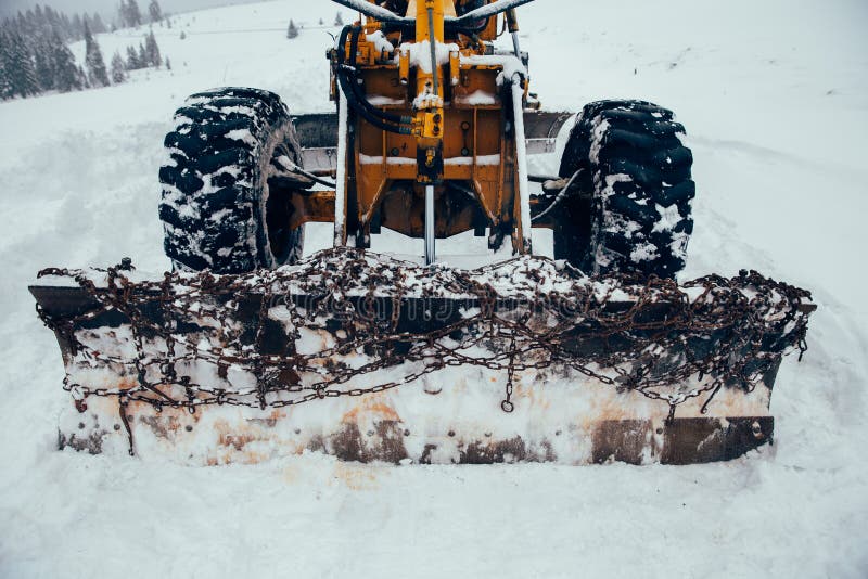 Old Snow Plow Cleaning Roads Covered in Snow Up in the Mountains Stock