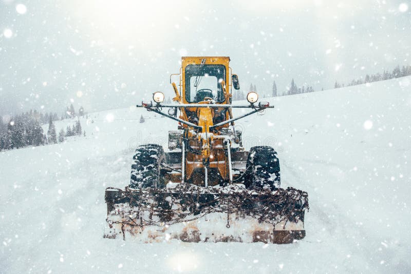 Old Snow Plow Cleaning Roads Covered in Snow Up in the Mountains Stock