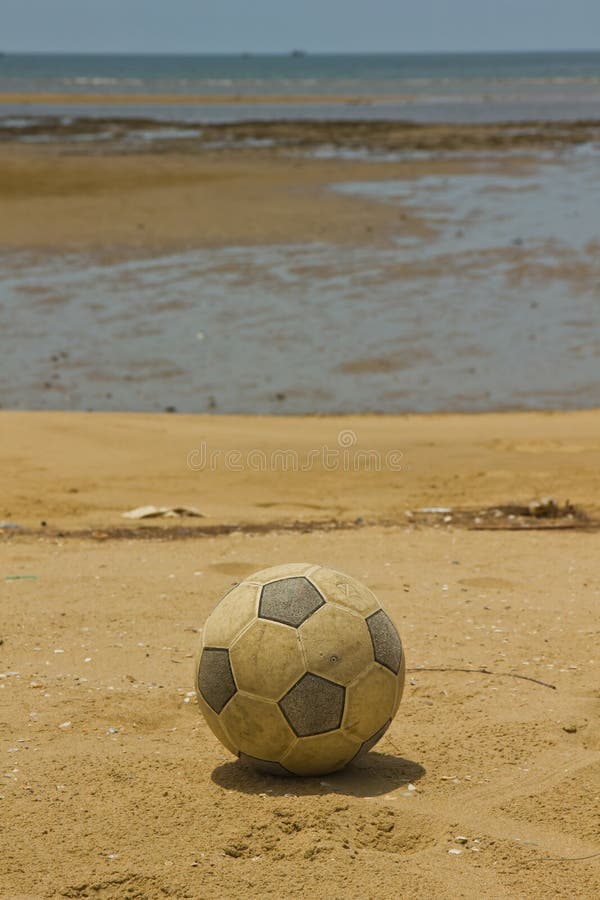 Old soccer ball on beach stock photo. Image of summer 25572296