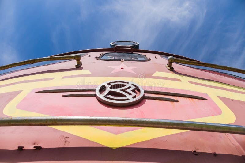 Old soviet locomotive train closeup under blue sky