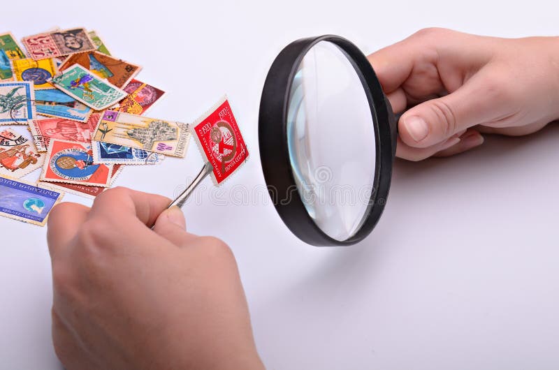 Old stamp in hands of the philatelist