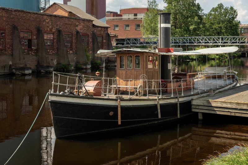 Old steam boat anchored at a pier stock photos Old steam boat anchored at a pier stock photos