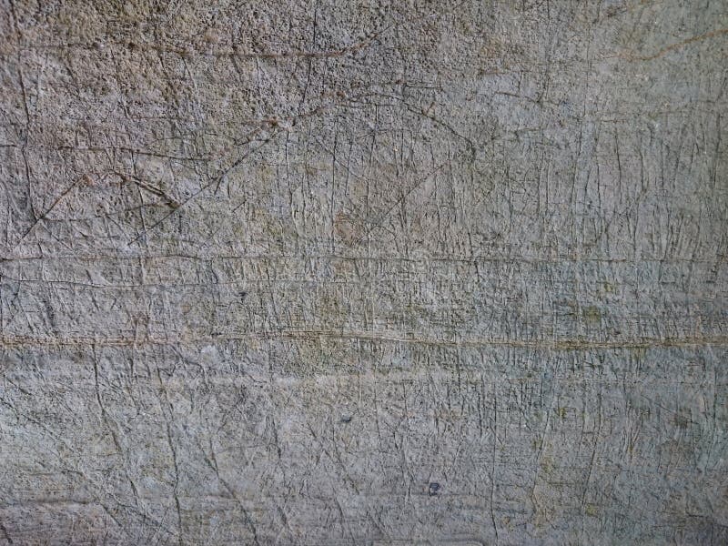 Old stone background texture. Cave wall rusty pattern scratched with marks. Grey ancient rock with levels or stripes, relief structure.