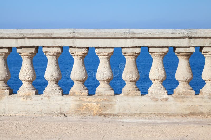 Old stone balustrade with blue sea and sky