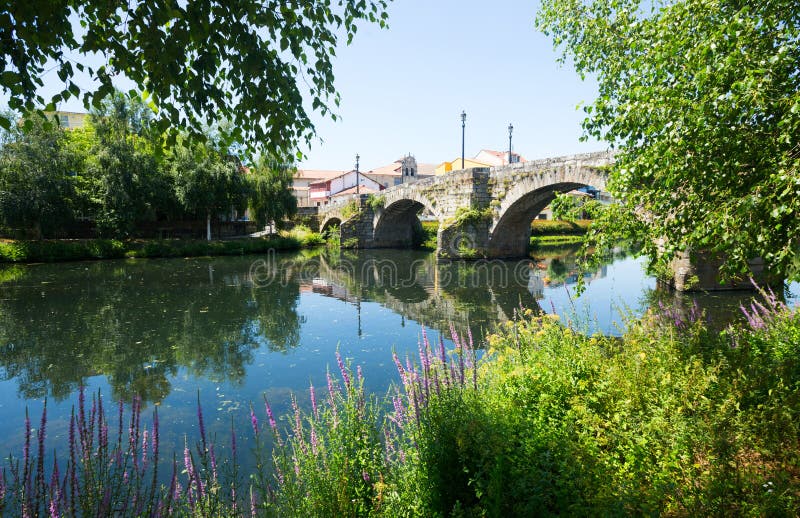 Old stone bridge at Monforte de Lemos in sunny day. Galicia, Spain