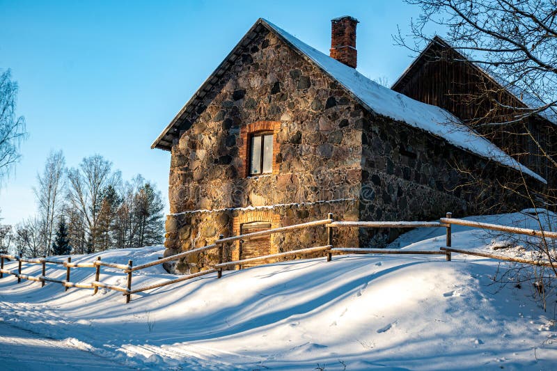 Old stone building illuminated by winter sun, winter day, low light stock photos