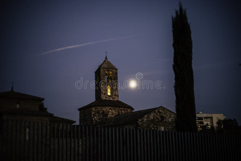 Old stone church on an evening with the moon close to the bell tower royalty free stock photos Old stone church on an evening with the moon close to the bell tower royalty free stock photos