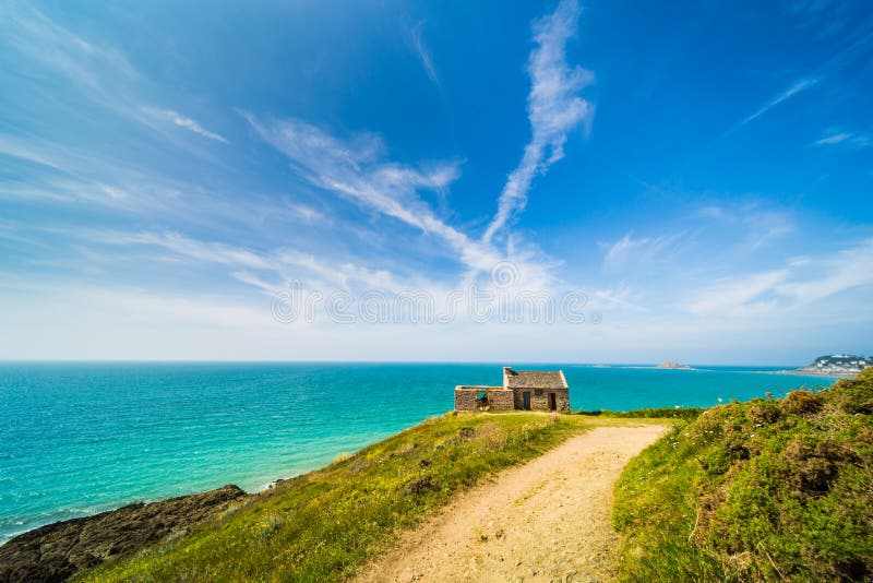 Old Stone House on and Turquoise Blue Atlantic Coast of Pléneuf-Val-André in Brittany France on a Sunny Summer Day royalty free stock photo Old Stone House on and Turquoise Blue Atlantic Coast of Pléneuf-Val-André in Brittany France on a Sunny Summer Day royalty free stock photo