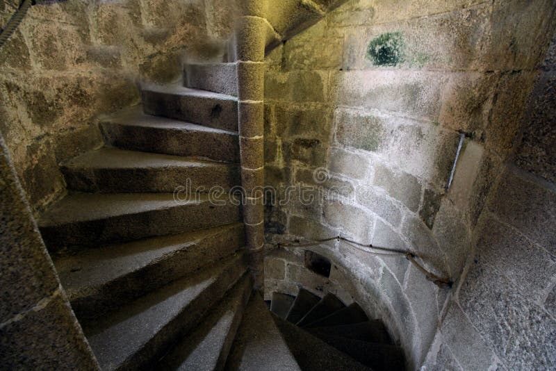 Old stone spiral staircase going up the inside of a castle tower