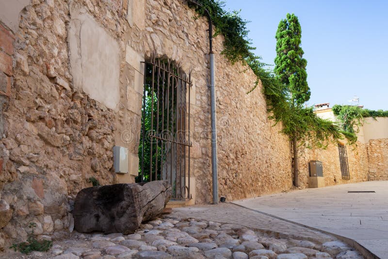 Old stone wall with closed door, street view