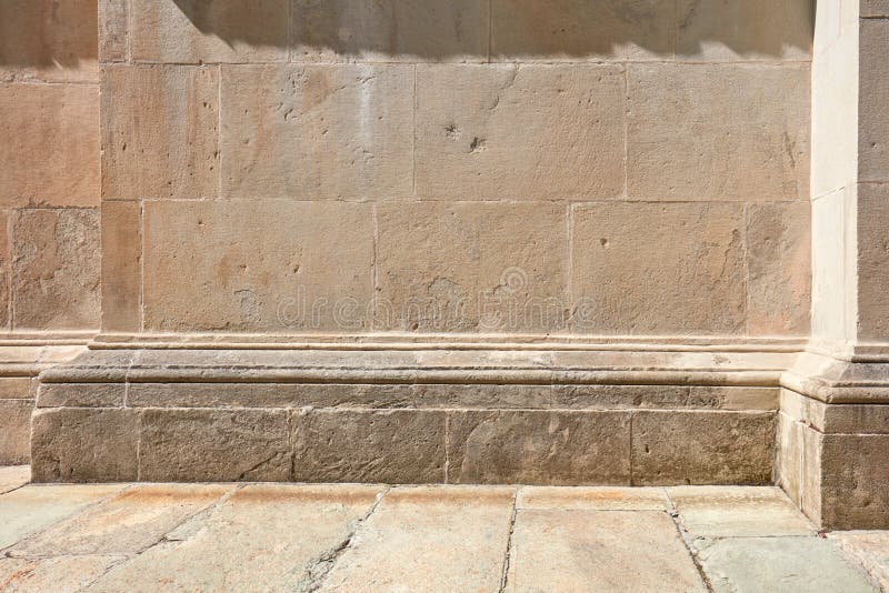 Old stone wall with molding and floor background in sunlight