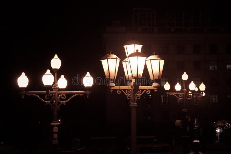 Old Street Electric Lights at Night on Black Background As Little