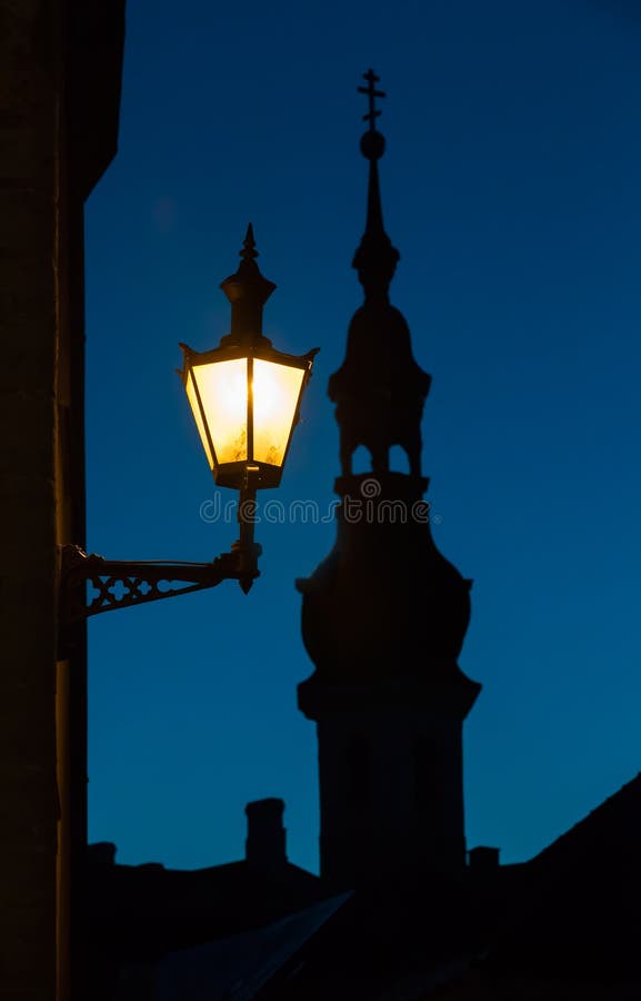 Old street lamp and church silhouette, Tallinn