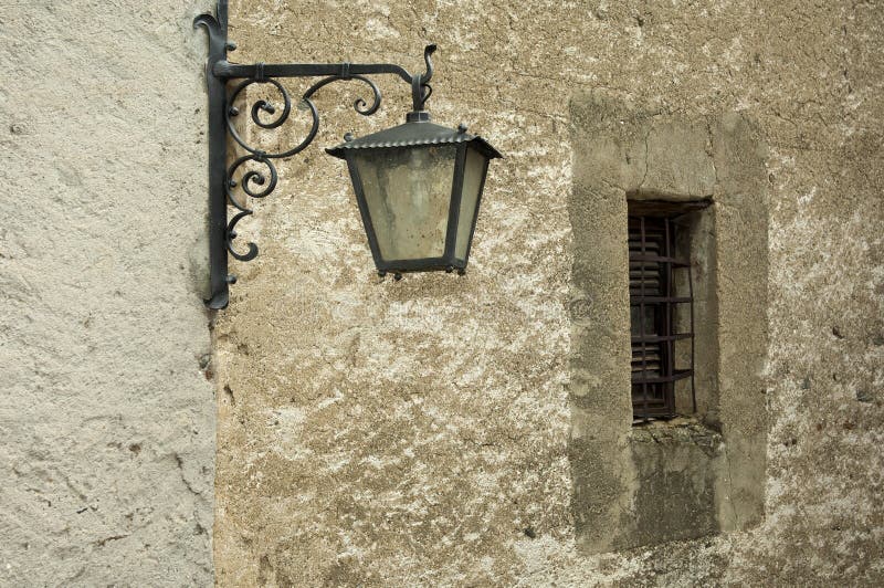 Old street light at a wall