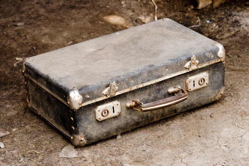 Old suitcase on the ground