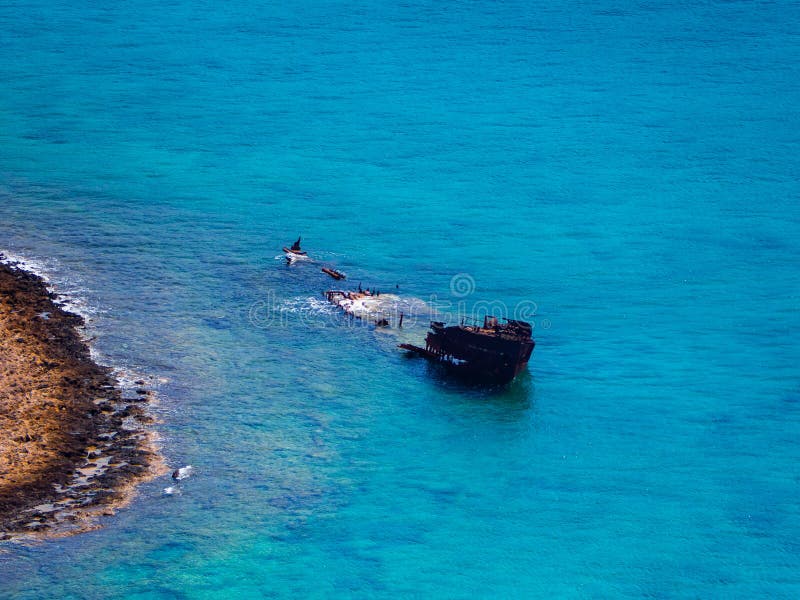 Old sunken and abandoned ship near rock shore stock photography Old sunken and abandoned ship near rock shore stock photography