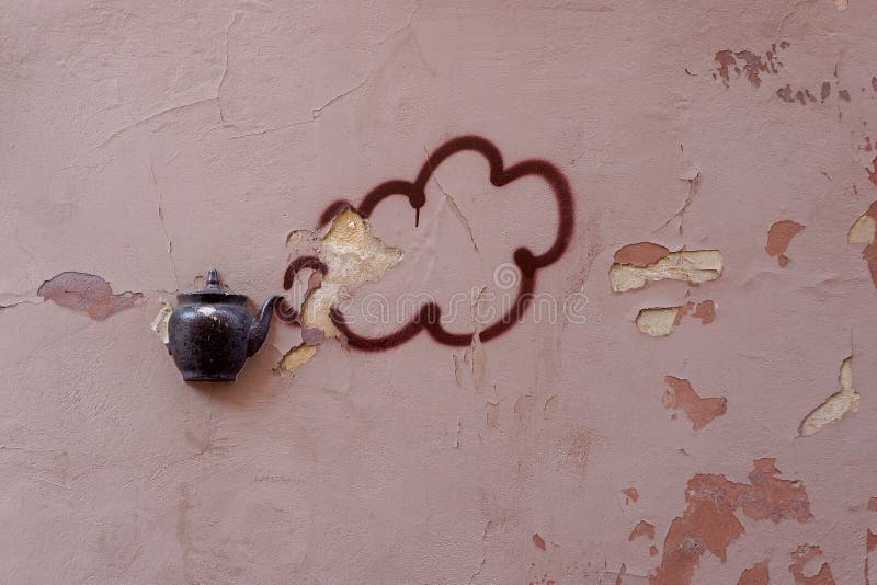 Old teapot on facade of building in Vilnius, Lithuania.