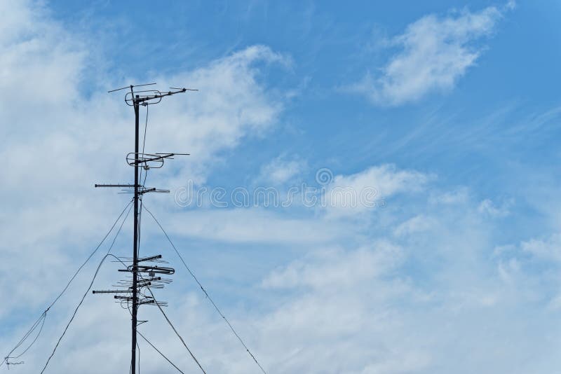Old television aerial against cloudy sky. Old television aerials are fixed on a metal mast against cloudy sky stock photos Old television aerial against cloudy sky. Old television aerials are fixed on a metal mast against cloudy sky stock photos