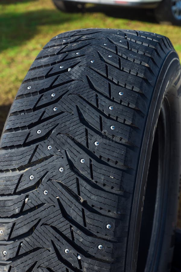 Old tires, car tire with spikes. grass background. royalty free stock photos