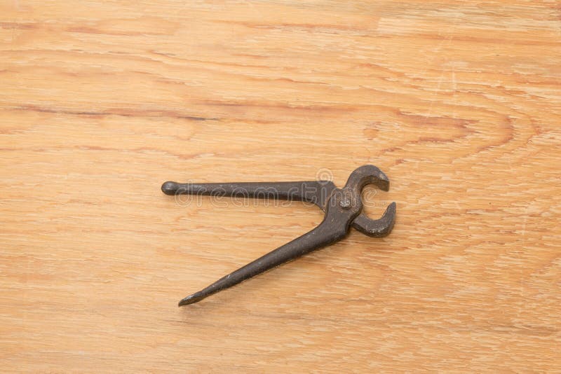Old tools. Pincers. A tool used for gripping and pulling things. Wooden background. The tool lies on a wooden table royalty free stock images Old tools. Pincers. A tool used for gripping and pulling things. Wooden background. The tool lies on a wooden table royalty free stock images