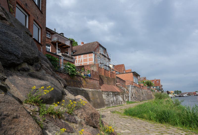 Old town of Lauenburg, coastal promenade and historic brick houses on the dike wall made of field stones on the river Elbe in stock photography Old town of Lauenburg, coastal promenade and historic brick houses on the dike wall made of field stones on the river Elbe in stock photography