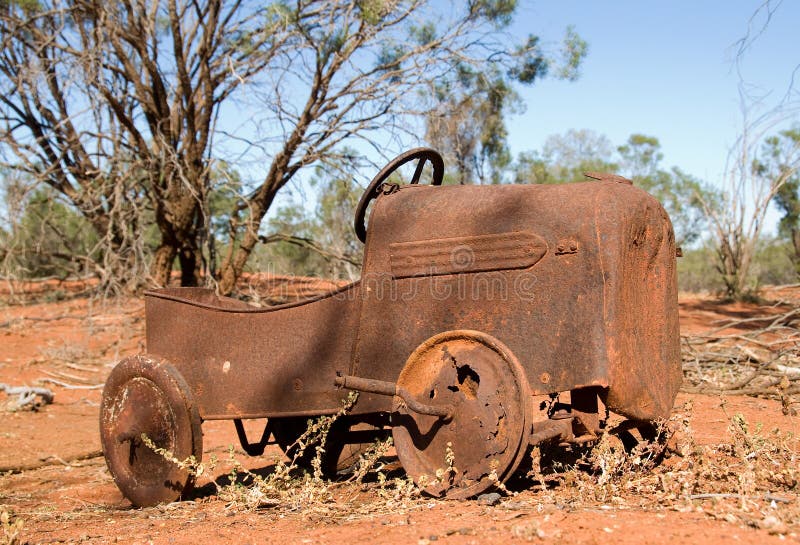 Old toy car rusting in the desert. stock photos