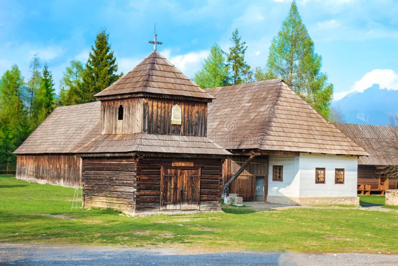 Old traditional houses and wooden belfry of village Pribylina in Liptov region SLOVAKIA - PANORAMA