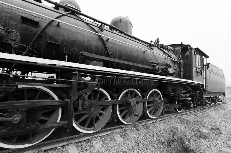 Old train locomotives with black and white photo.